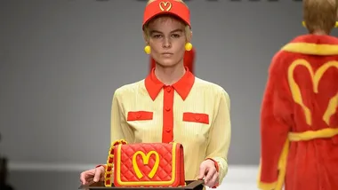 Woman carrying bag with logo that appears to McDonalds inspired