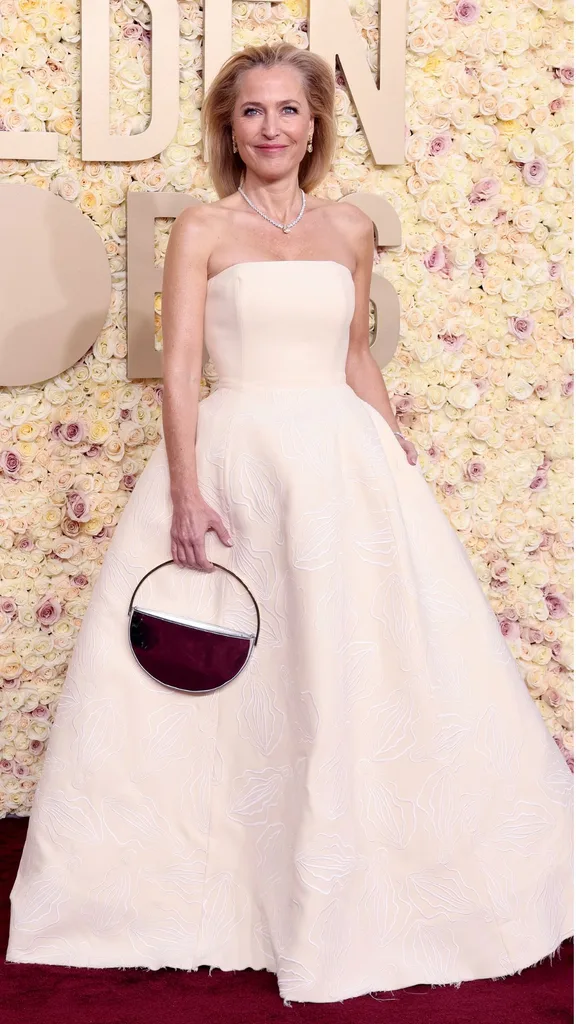 Gillian Anderson wears Gabriela Hearst and an Aquazzura bag to the 2024 Golden Globes. 