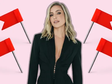 A woman in a black outfit stands surrounded by four red flags on a light pink background.