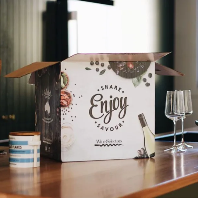Open Wine Selectors box on table with glasses and a tub, featuring the words "Share, Enjoy, Savour".