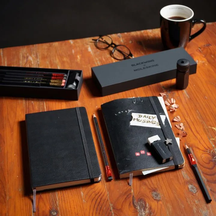 Moleskin are famous for the notebooks that feel luxe and keep you organised. One of the best stationery brands to shop in Australia. Pictured are two notebooks, one for work one for "daily musings", along with plenty of pencils and a cup of coffee. 