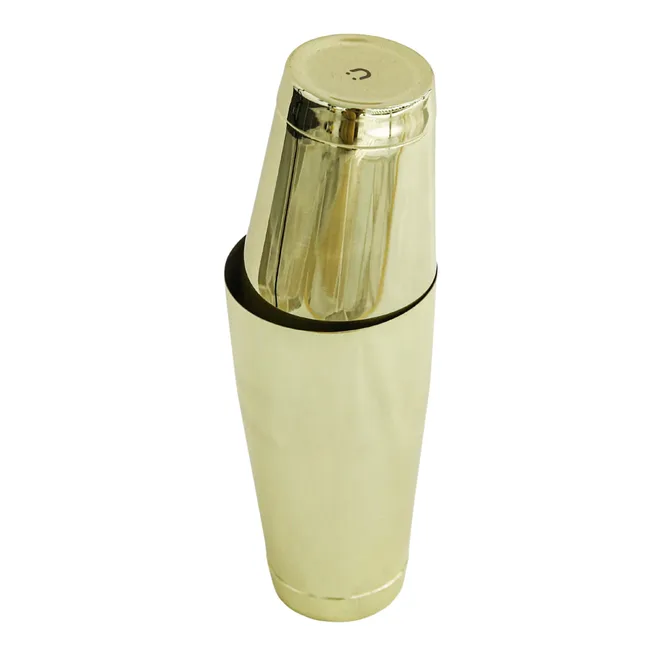 A gold-colored cocktail shaker with a polished finish.