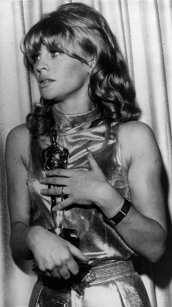 British actress Julie Christie holds the Academy Award she won for her role in the film 'Darling' (1965), making Oscars history.