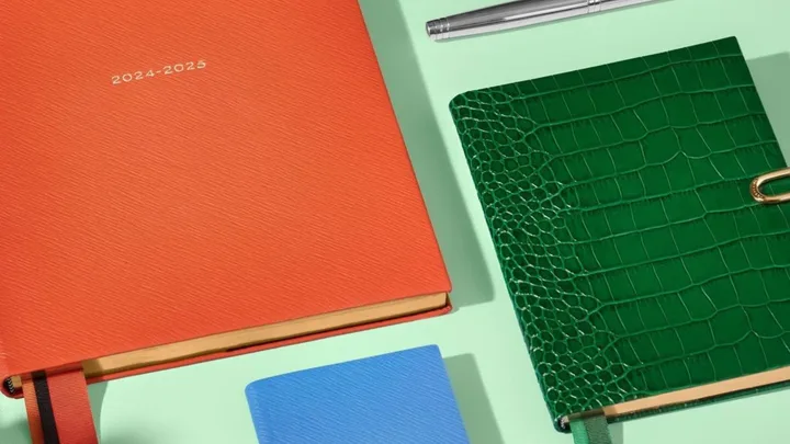 Stationery from Smythson will bring bright, personalised colour to your home office. Pictured are notebooks and planners in bright orange, emerald green faux crock leather and pastel blue.