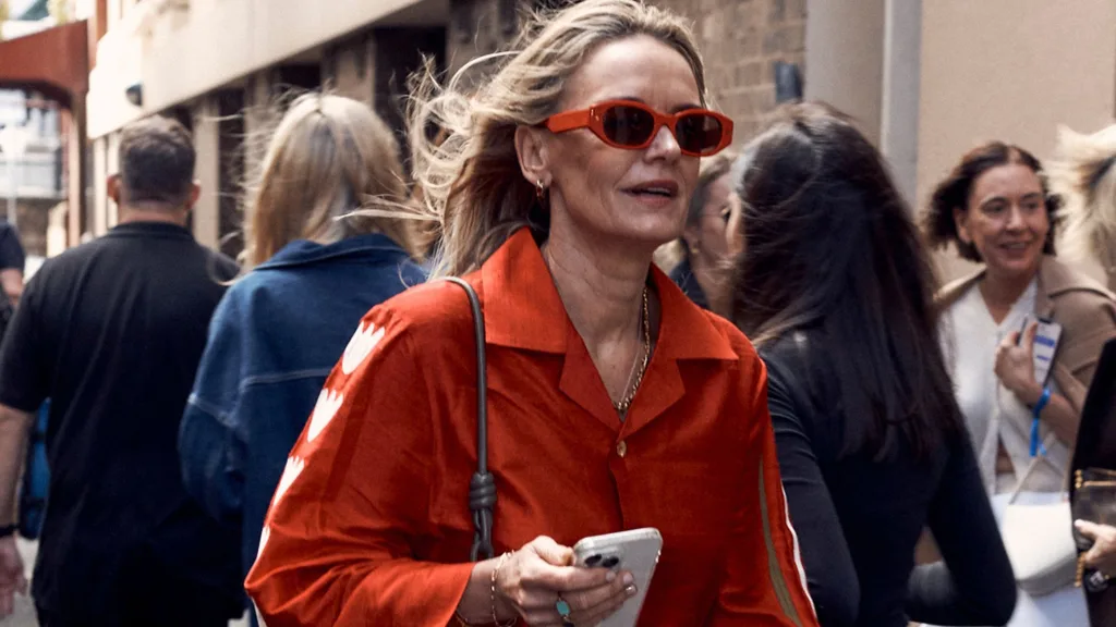 a street style image of a woman in orange from australian fashion week 2024