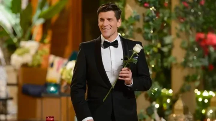 osher holds a rose on the bachelor australia