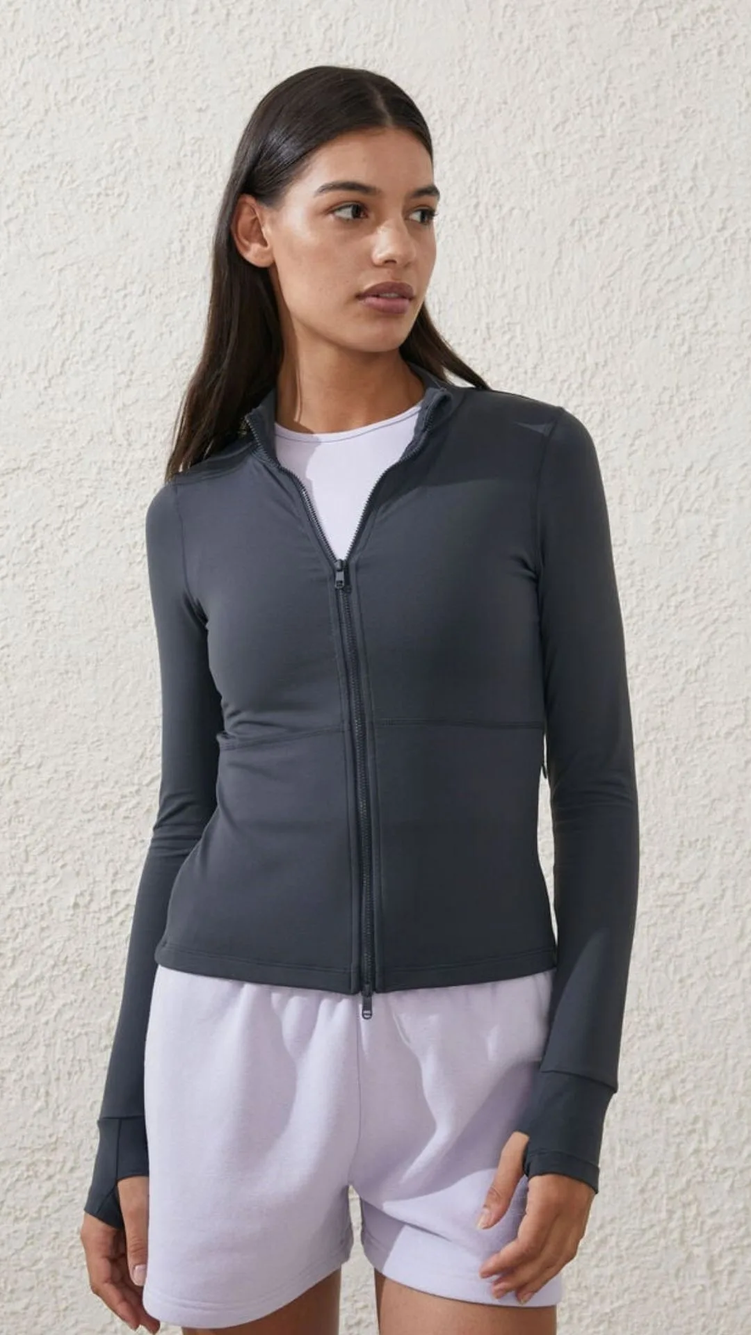 a woman wears a zippered Long-sleeve Womens Activewear Top