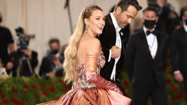 blake lively and ryan reynolds make their way up the stairs and inside the met gala.