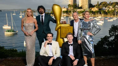 nominees for the 2024 logies stand against the background of sydney harbour with an oversized gold logie statue between them