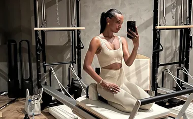 Model Jasmine Tookes on a reformer pilates machine