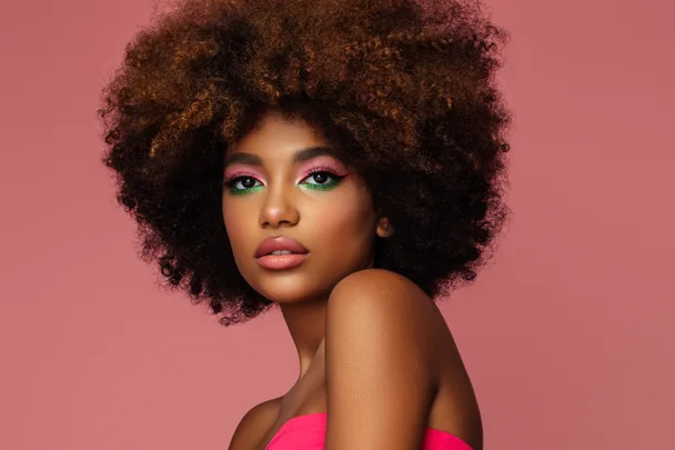 beautiful afro woman with bright makeup on pink background