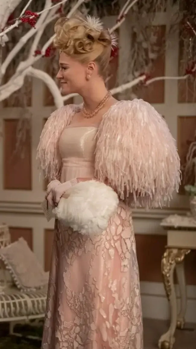Elegant woman in ornate pink gown with fur shawl, intricate hairstyle. Victorian decor setting.