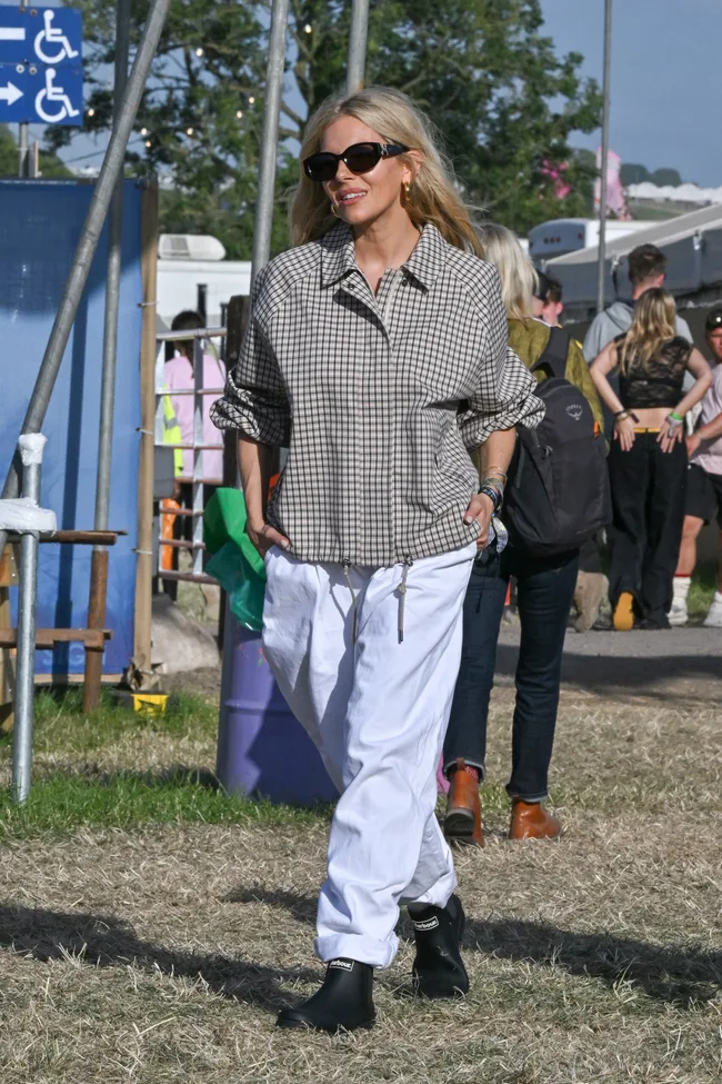 Sienna Miller wears a check jacket and white cargo pants at glastonbury