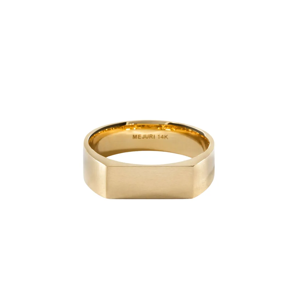 This gender-neutral ring features a slim, long rectangular face and adds a masculine edge that is perfect for toughening up a feminine look whether you wear it with contrasting pieces in a stack, or alone.  