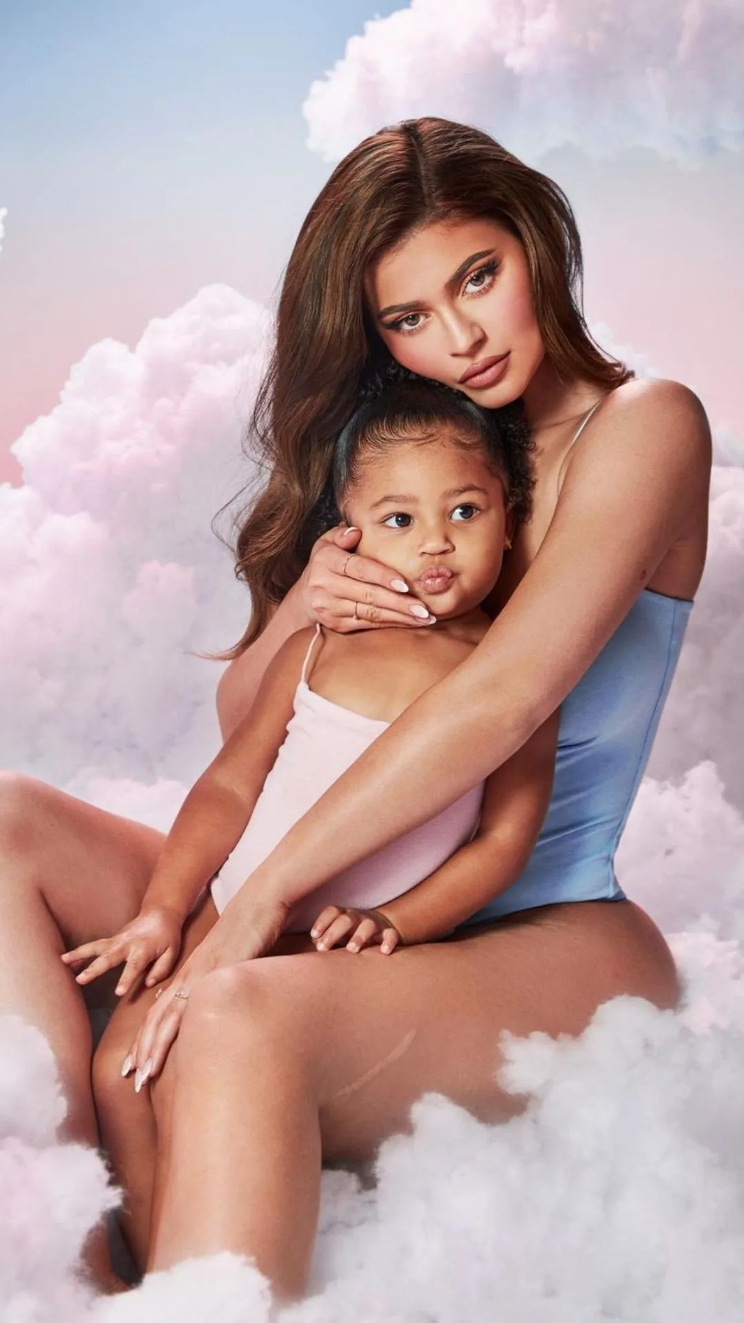 kylie jenner poses with her daughter Stormi in her lap in a campaign shot for her business, Kylie baby