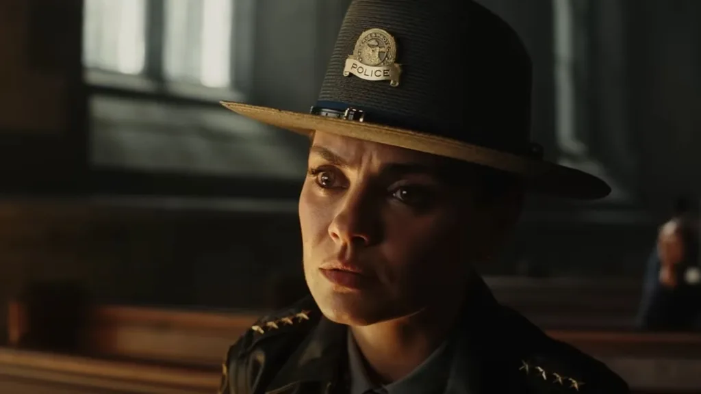 A woman wearing a sheriff's hat looking concerned.
