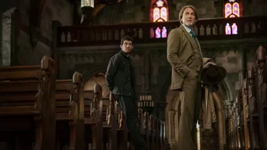 Two men in the centre of a church.
