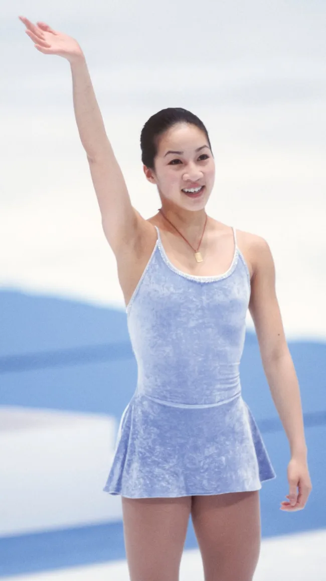 Michelle Kwan wears a dress by fashion designer Vera Wang at the winter olympic games