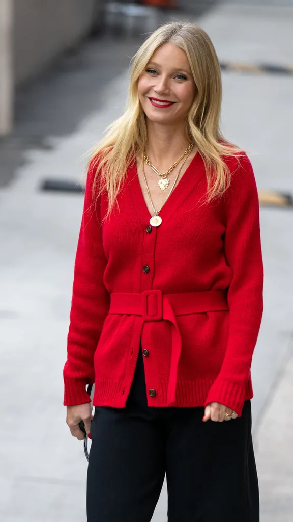 Gwyneth Paltrow wears a red cardigan.