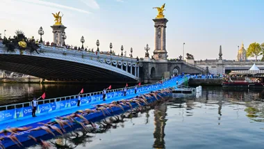 Swimmers dive into the Seine during a Test Event for the women's triathlon for the 2024 Paris Olympics