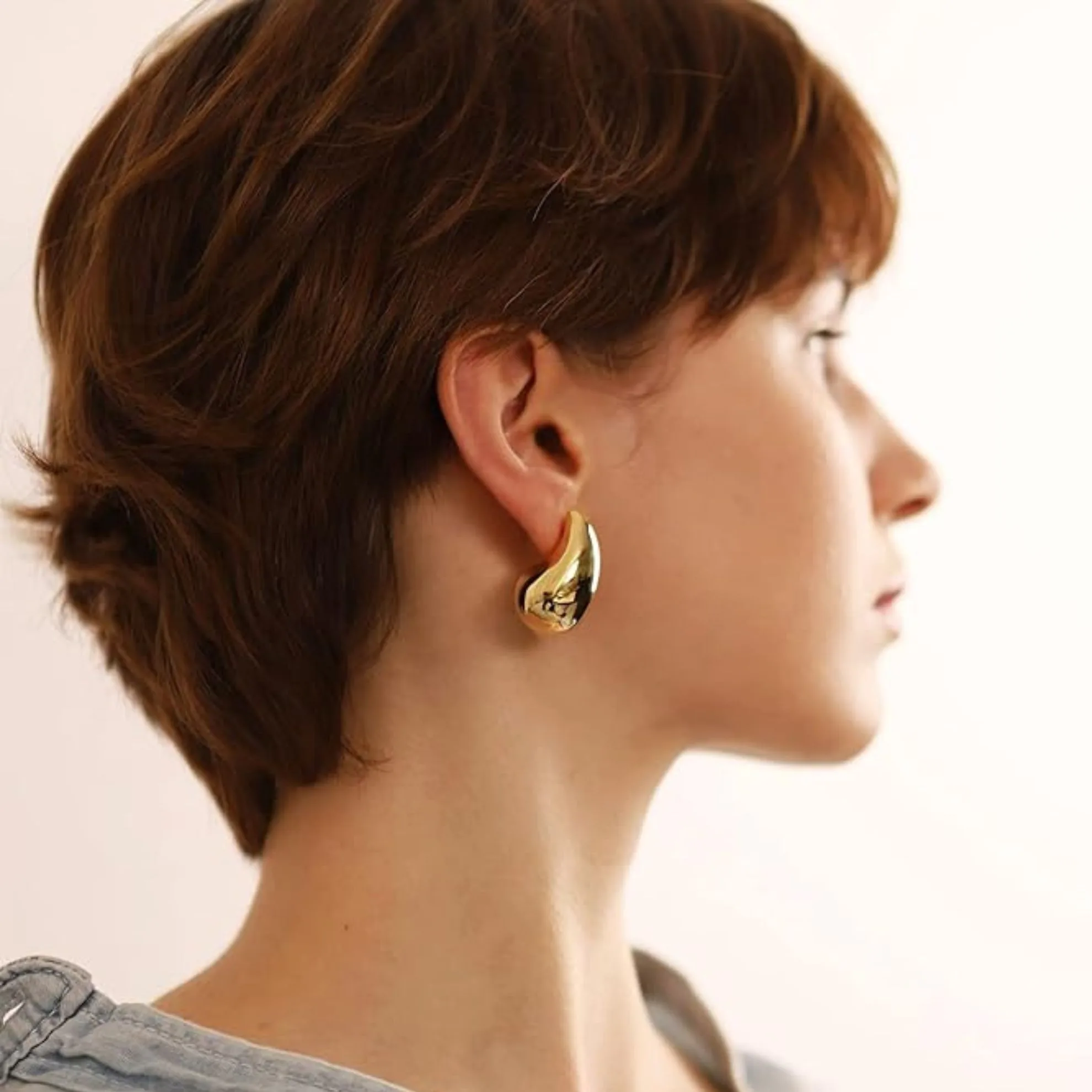 The teardrop earring is having a moment and these beautifully curved, slightly oversized gold-plated studs curve around the early lobe and will elevate any look. 