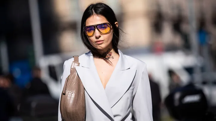 Doina Ciobanu, wearing Carrera sunglasses and grey jacket and pants, is seen outside Sportmax on Day 3 Milan Fashion Week Autumn/Winter