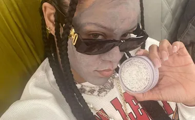 Rihanna wearing a face mask on a plane