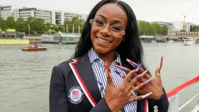 Sha'Carri Richardson poses for a photo while riding with teammates on a boat with teammates along the Seine River during the Opening Ceremony of the Olympic Games Paris 2024 on July 26, 2024 in Paris, France.