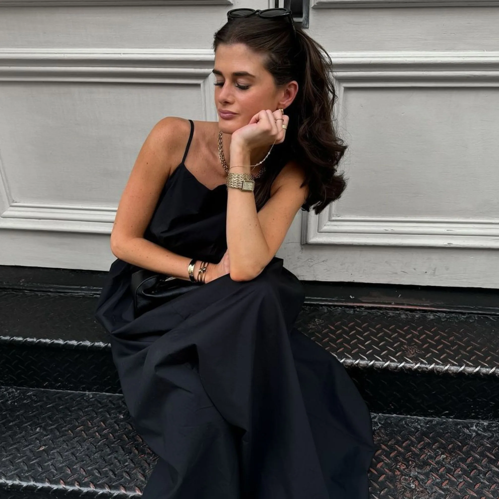 woman wears black dress and vintage watch