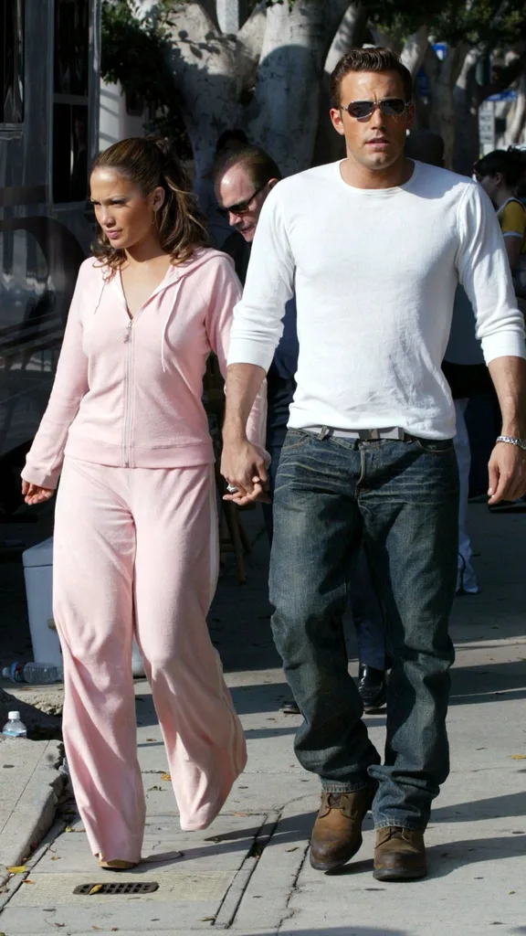 Actress/singer Jennifer Lopez and actor Ben Affleck hold hands while filming her new music video at Barefoot restaurant on October 20, 2002 in Beverly Hills