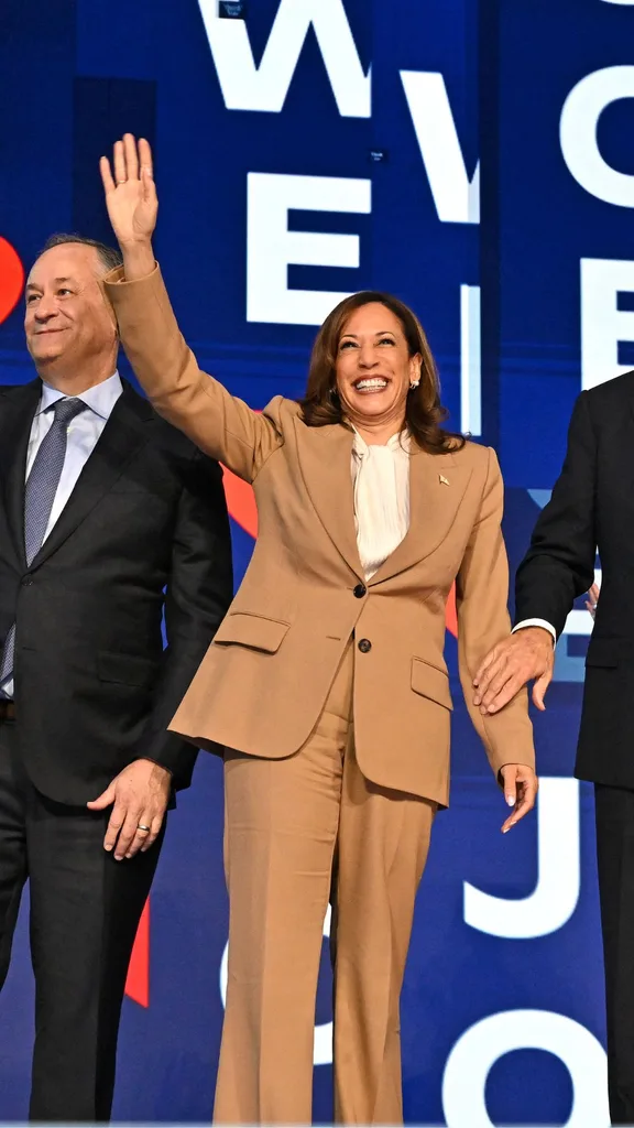 US President Joe Biden holds US Vice President and 2024 Democratic presidential candidate Kamala Harris arm after delivering the keynote address, as the Biden family stands alongside, on the first day of the Democratic National Convention (DNC) at the United Center in Chicago, Illinois, on August 19, 2024. Vice President Kamala Harris will formally accept the party's nomination for president at the DNC which runs from August 19-22 in Chicago. 