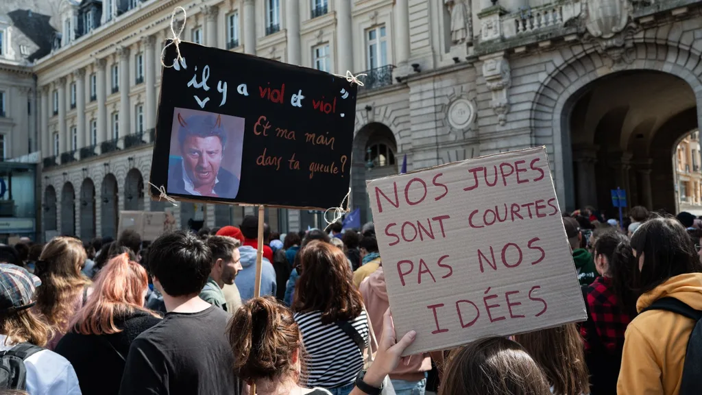 A crowd of people holding placards in support of Gisele Pelicot in France