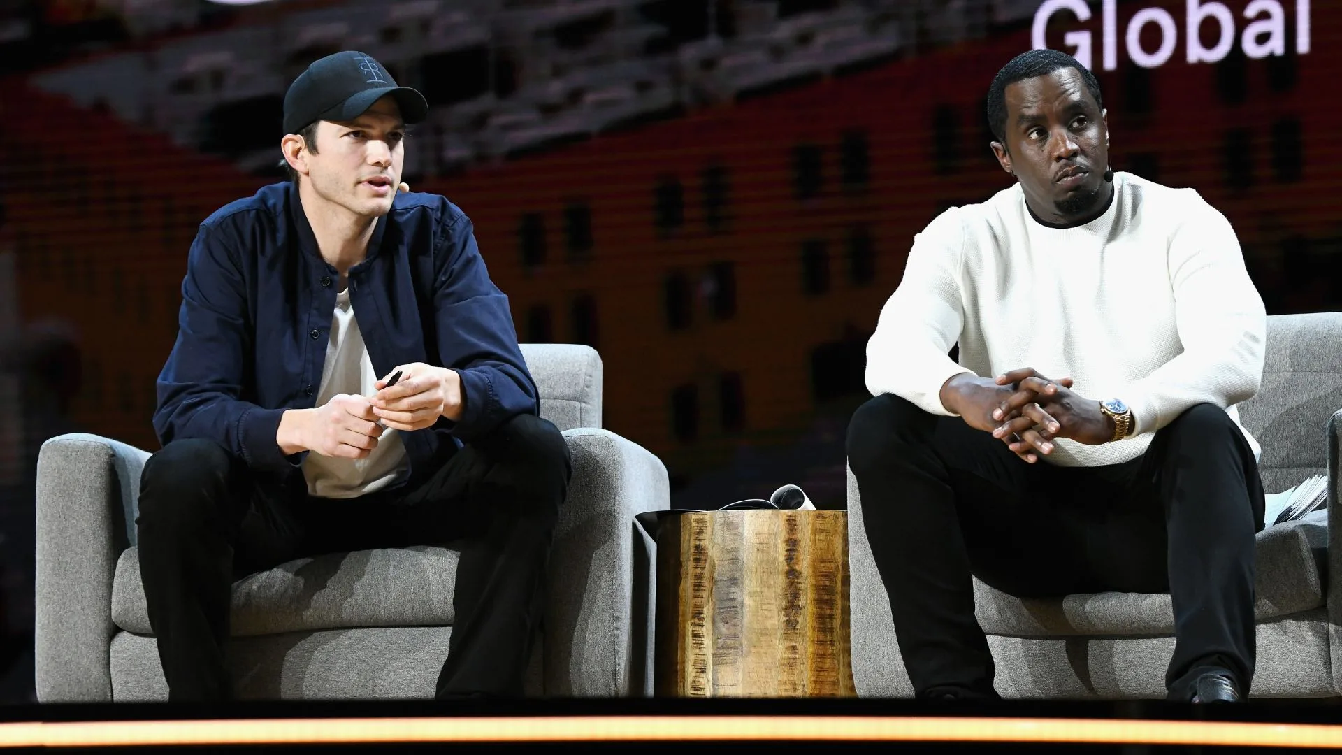 Ashton Kutcher (L) and Sean Combs speak onstage during WeWork Presents Second Annual Creator Global Finals at Microsoft Theater 