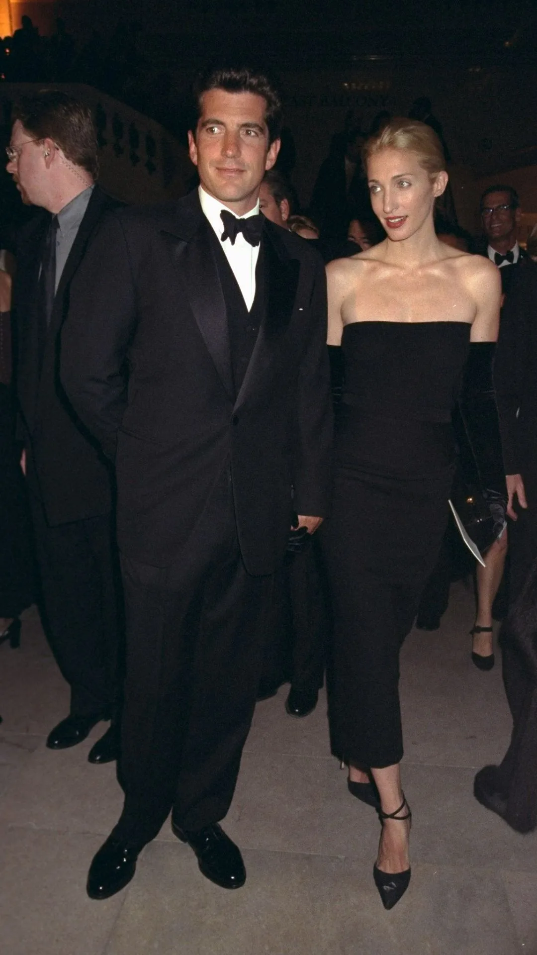 John F. Kennedy Jr. with his wife Carolyn Bessette Kennedy attending Municipal Art Society gala dressed in black tie attire.