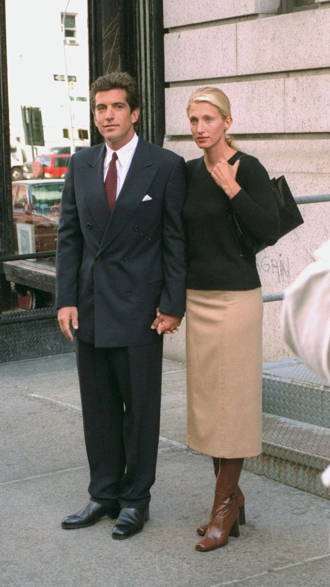 John F. Kennedy Jr. and bride Carolyn Bessette Kennedy stand in front of their apartment in Tribecca