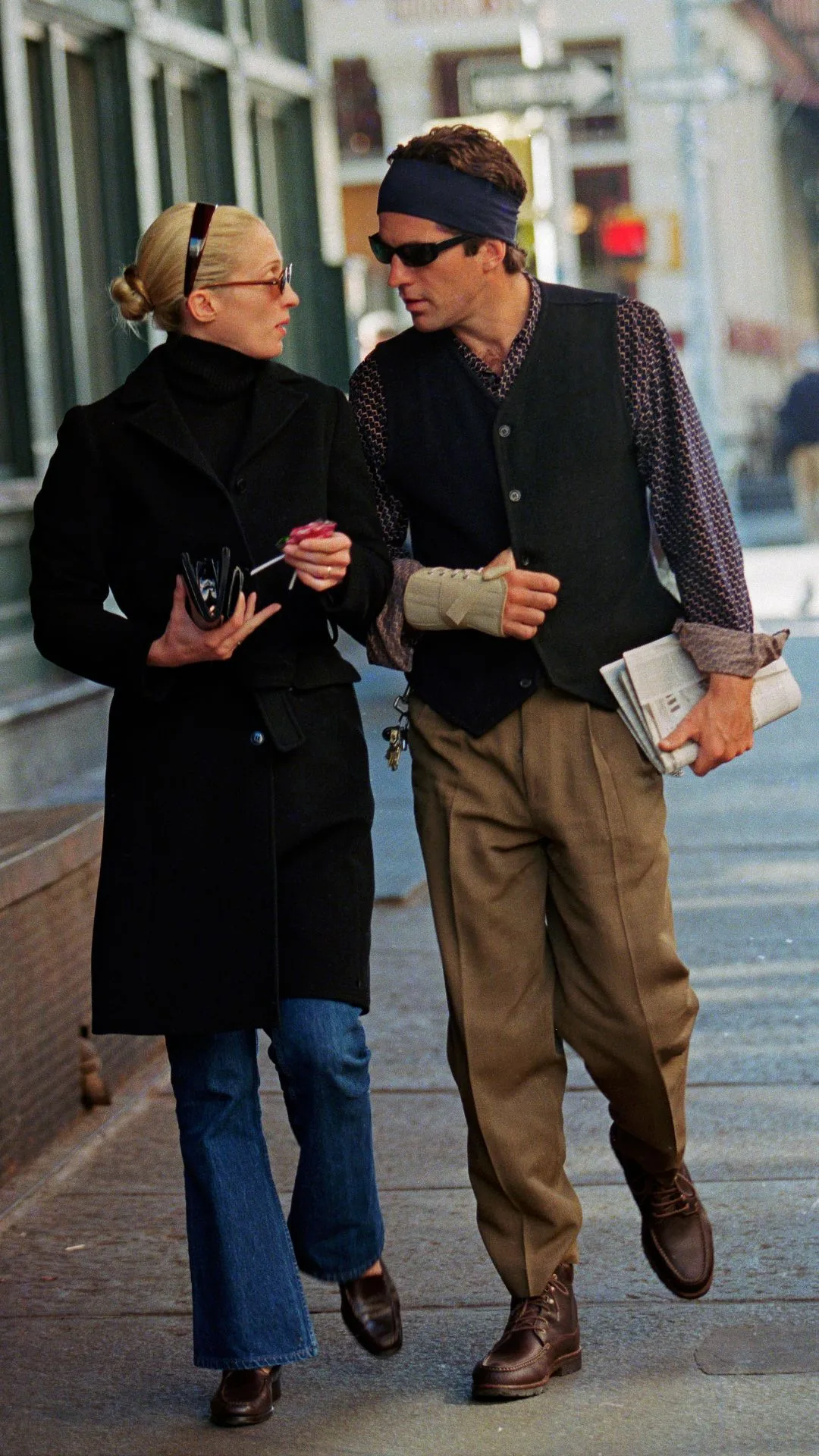 Carolyn Bessette walks in New York with husband John F Kennedy Jr. in jeans and coat 