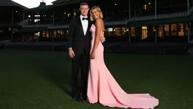 Chad Warner wearing a black tuxedo and white shirt and partner Alice Hughes wearing a long pink strapless gown arrive at Sydney Swans Brownlow Medal Function at Sydney Cricket Ground