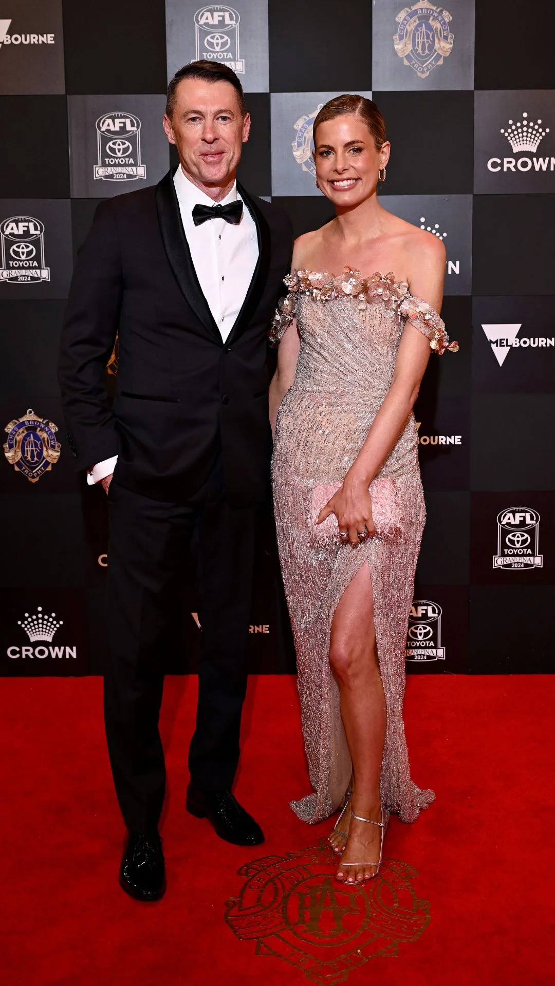 Craig McRae, coach of Collingwood and wife Gabrielle McRae in a sheer dress on the Brownlow red carpet