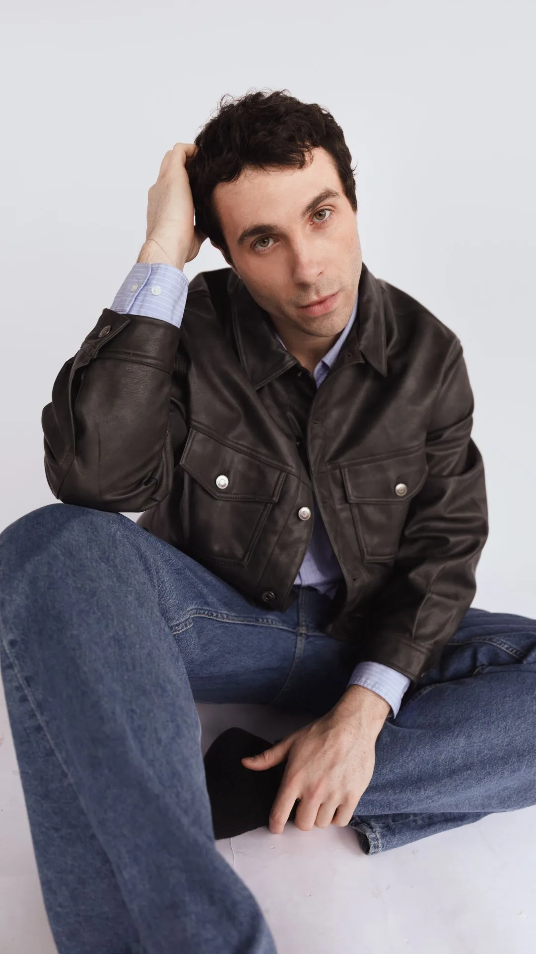 james Parr photographed in blue jeans and brown leather jacket