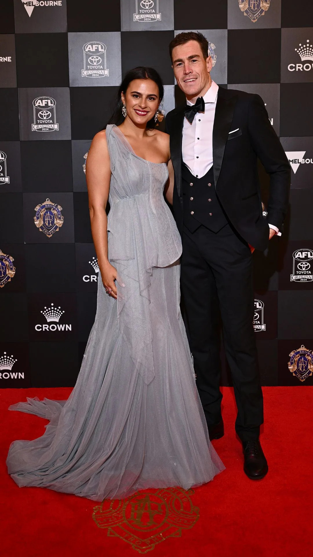 Jeremy Cameron and partner Indi Putra in a light grey flowing gown on the Brownlow Medal 2024 red carpet