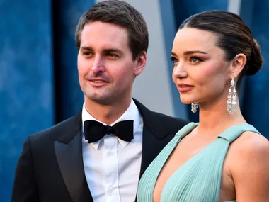 Evan Spiegel and wife Miranda Kerr posing on the red carpet