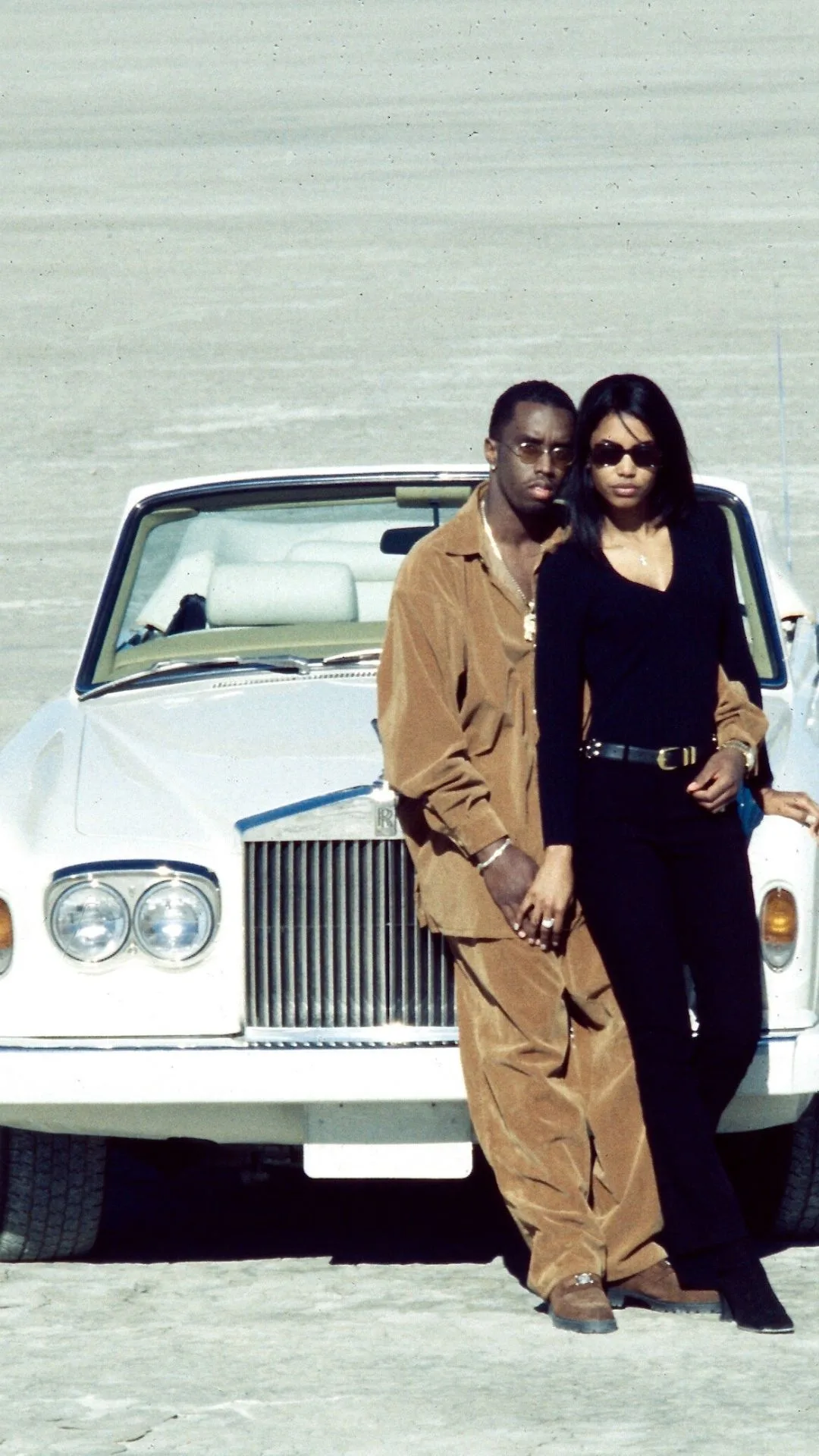 Portrait of American couple, rapper Sean Combs and Kimberly Porter (1970 - 2018), as they pose on the set of the 'Can't Nobody Hold Me Down' music video 