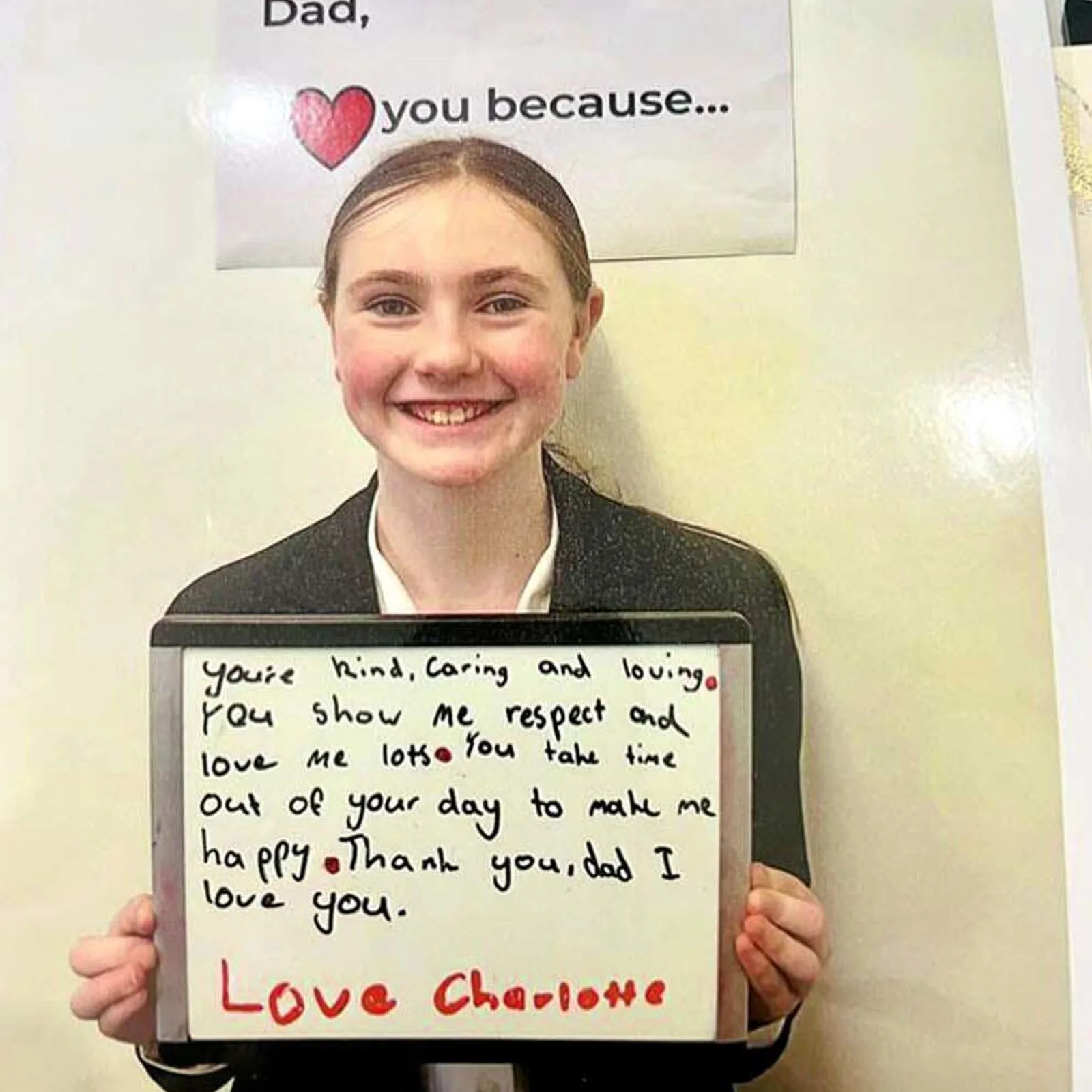 Charlotte holding a sign for her Dad on Father's Day