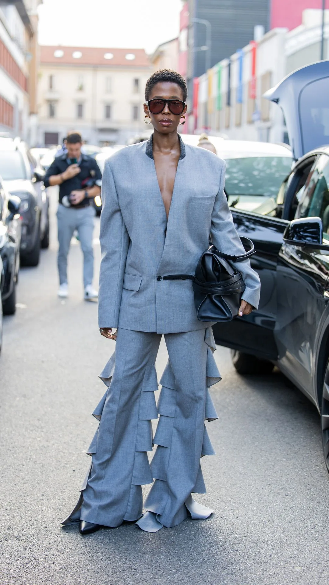 milan fashion week 2024 guest wears grey frill suit 