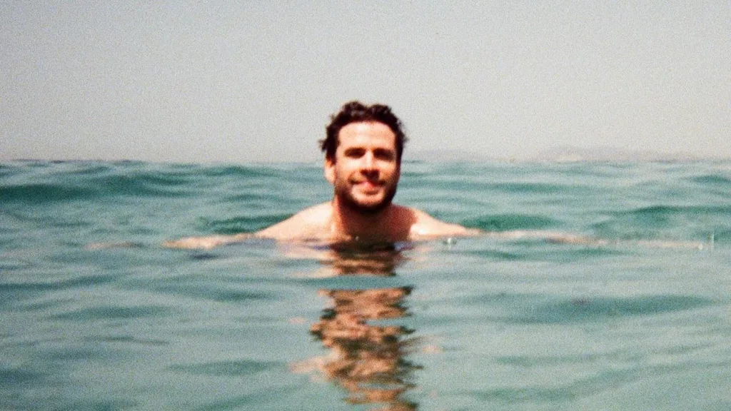 Liam Hemsworth's head bobbing out of the ocean in a picture posted to his girlfriend's instagram.