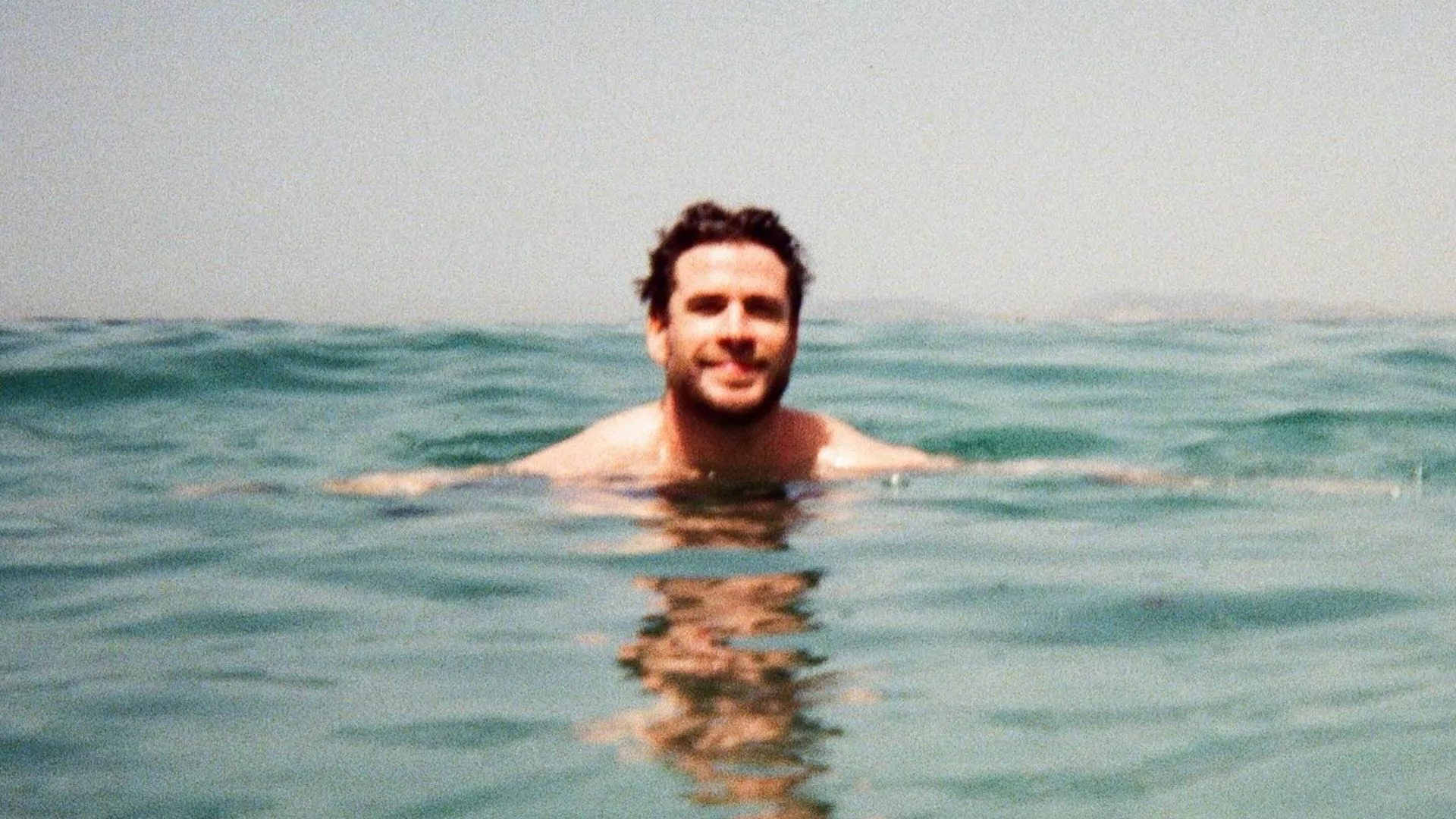 Liam Hemsworth's head bobbing out of the ocean in a picture posted to his girlfriend's instagram. 