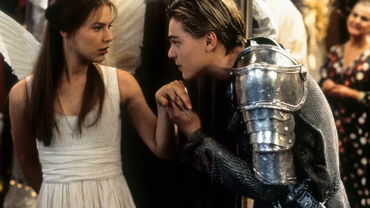 Claire Danes is surprised as Leonardo DiCaprio takes her hand to kiss in scene from the film 'Romeo + Juliet', 1996