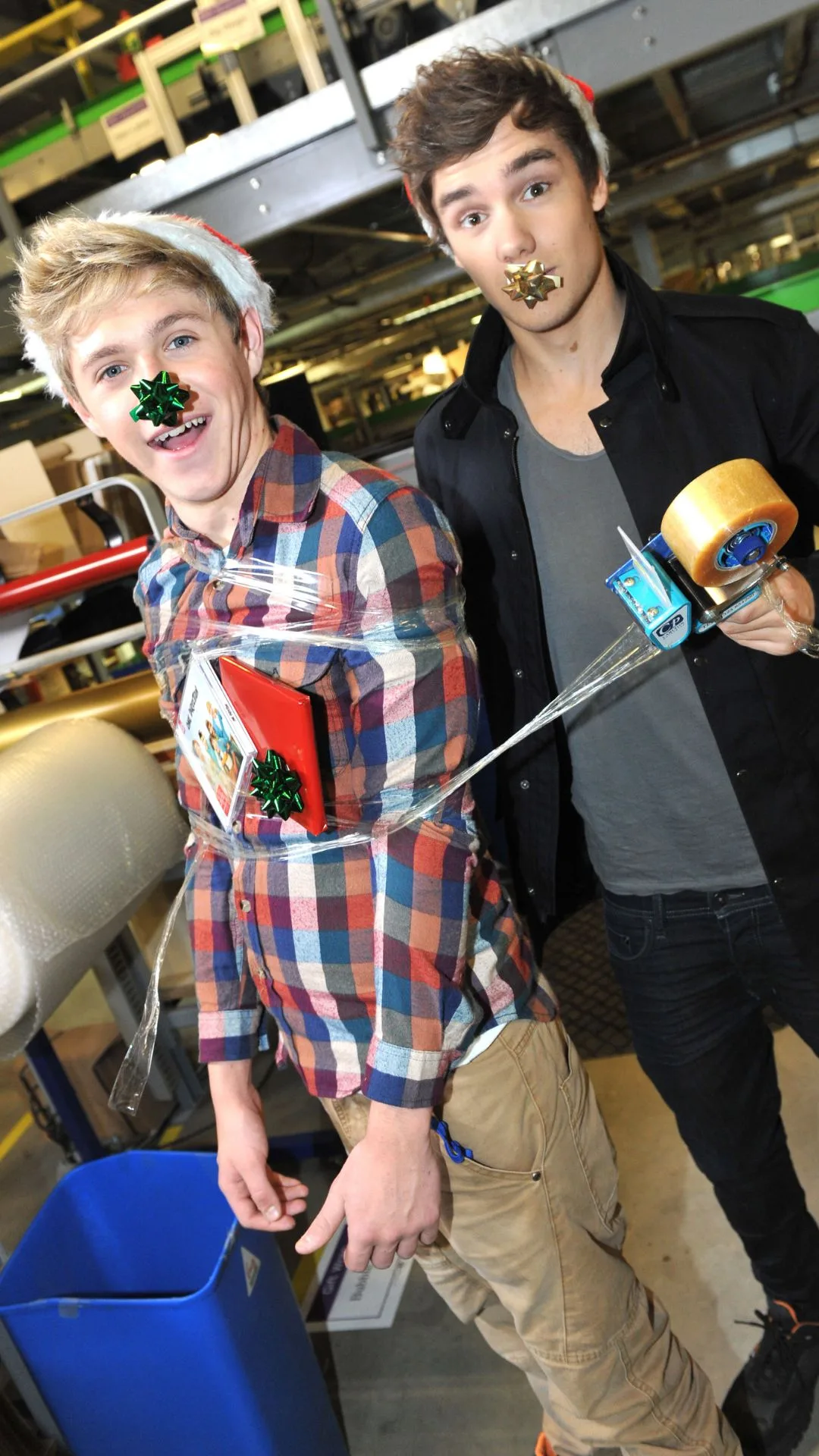 Niall Horan (L) and Liam Payne launch new album and Black Friday Deals Week at Amazon.co.uk's warehouse at Marston Gate Fulfilment Centre on November 21, 2011