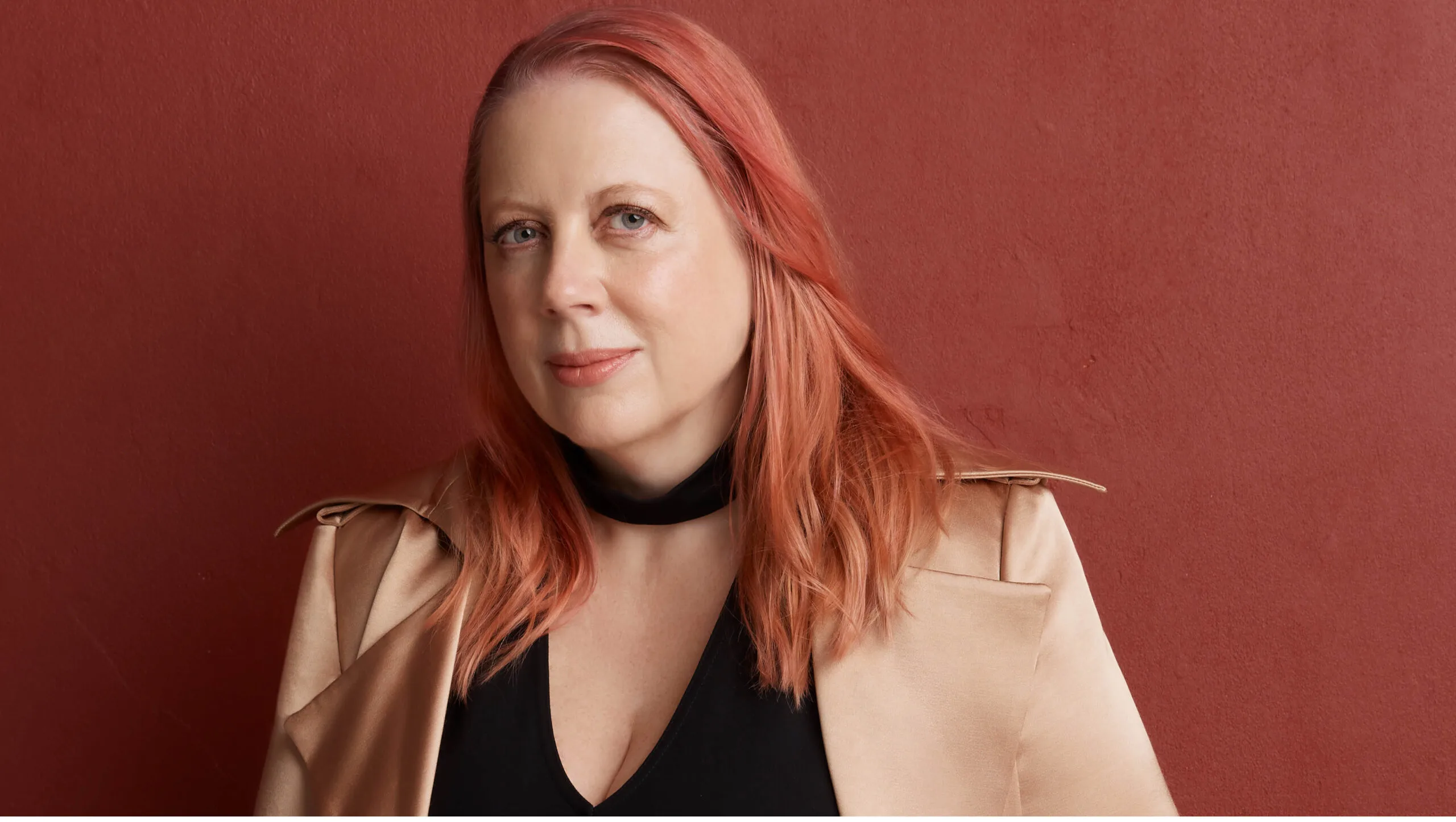 Annabel Daniel OAM against a red background