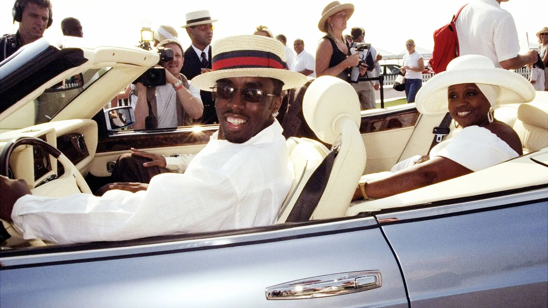 Sean Combs and his mother, Janice, arrive at a star-studded auction at the Bridgehampton Polo Club